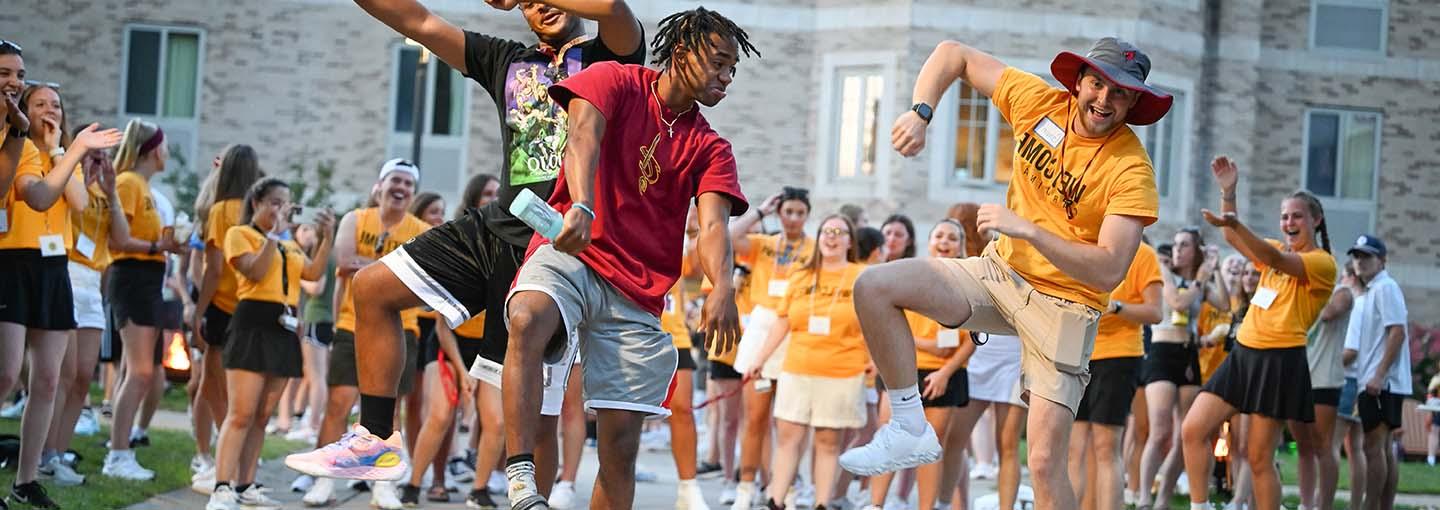 A group of students dancing and celebrating the start of the semester at Fisher.